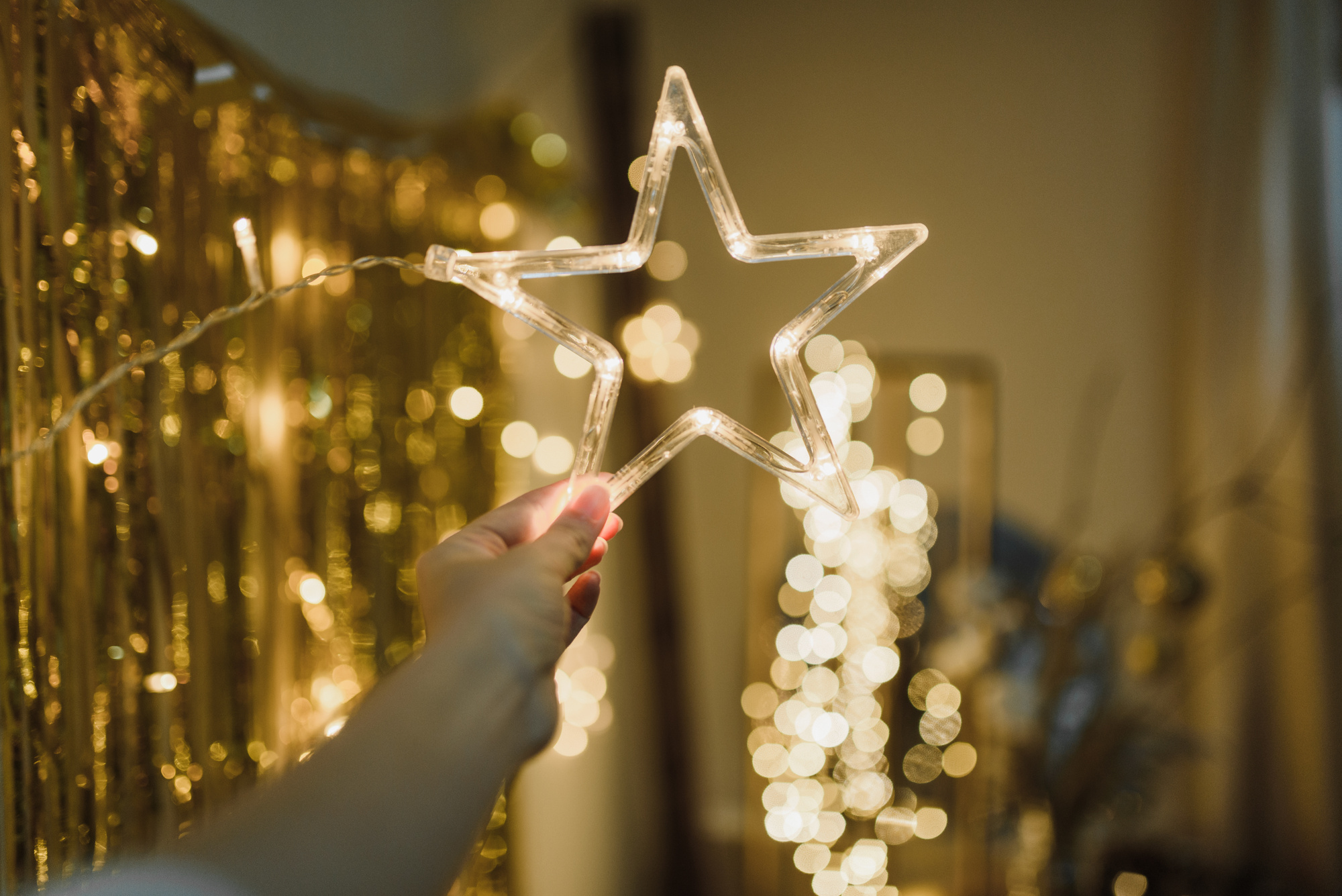 Woman Holding Illuminated Star Shape Christmas Decoration 